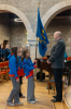 Rev Fergus Cook receives the colours from the Guides Colour Party